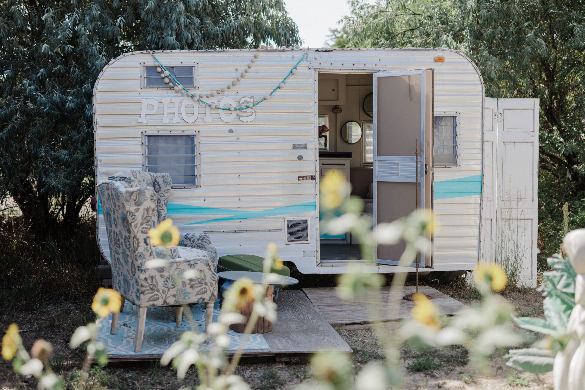 a camper photo booth is set up for a rustic wedding in colorado