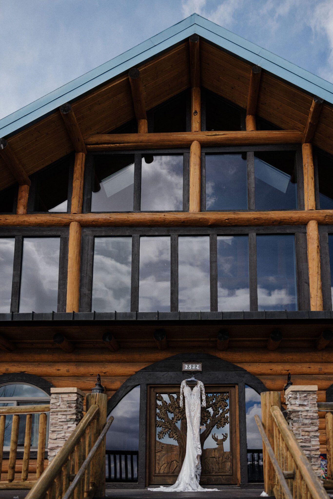 wedding dress hangs on the door of an airbnb before rustic wedding in colorado