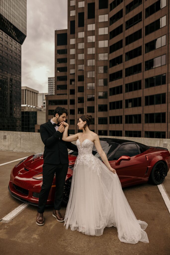 groom kisses bride's hand during bridal portrait session in downtown denver colorado.
