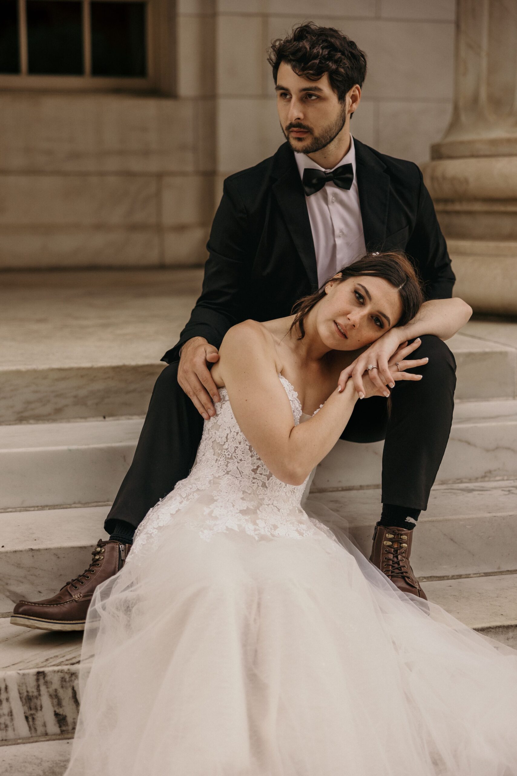 bride leans head on grooms lap during bridal portraits at byron white courthouse.