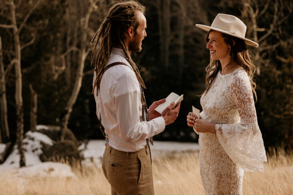 bride and groom read self written vows during colorado adventure elopement.
