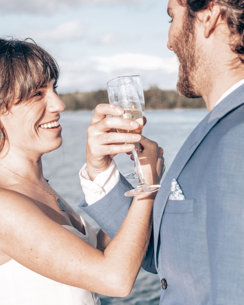 bride and groom sip champagne during adventure elopement in colorado.