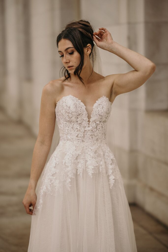 bride poses for elopement photographer during bridal portrait session at byron white courthouse in denver..