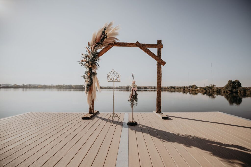 wooden altar with rustic bouquet overlooking the water during colorado elopement.