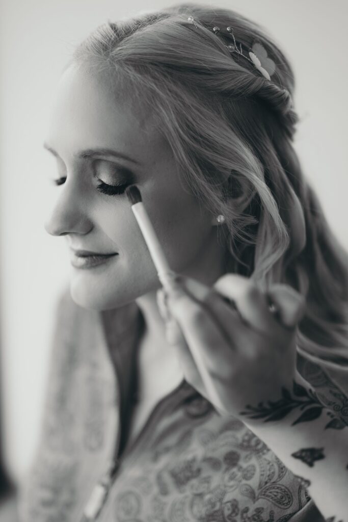 close up image of bride getting ready at salon, during pre-wedding photos with colorado wedding photographer.