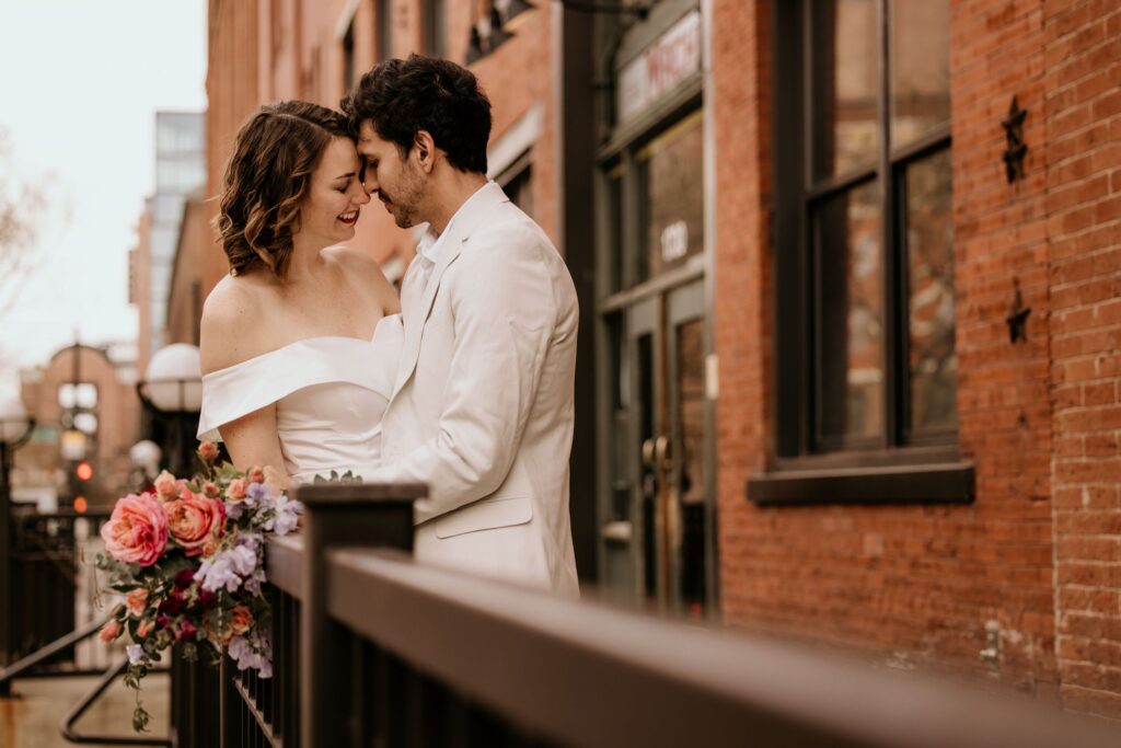 Newly married couple stands nose to nose during wedding portraits by colorado elopement photographer.