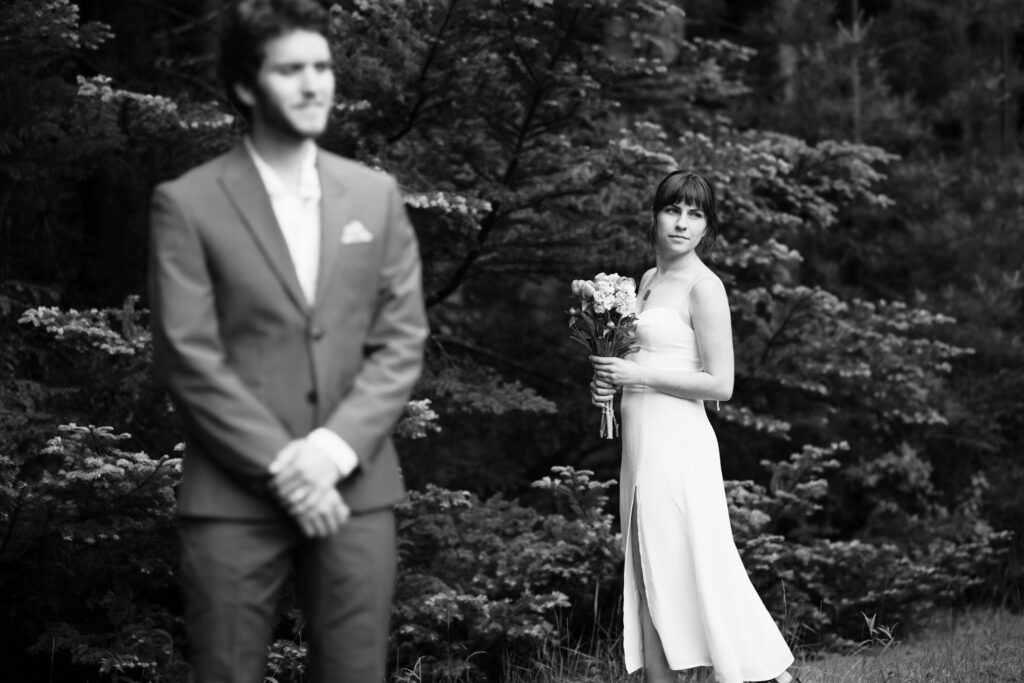 Black and white image: a couple is about to do their first look during Intimate Colorado Wedding Photos.