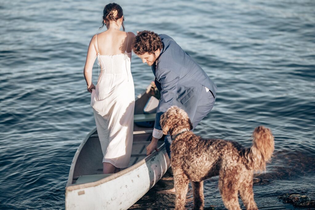 Newly married couple gets in their canoe with their dog during Colorado Elopement Photos.