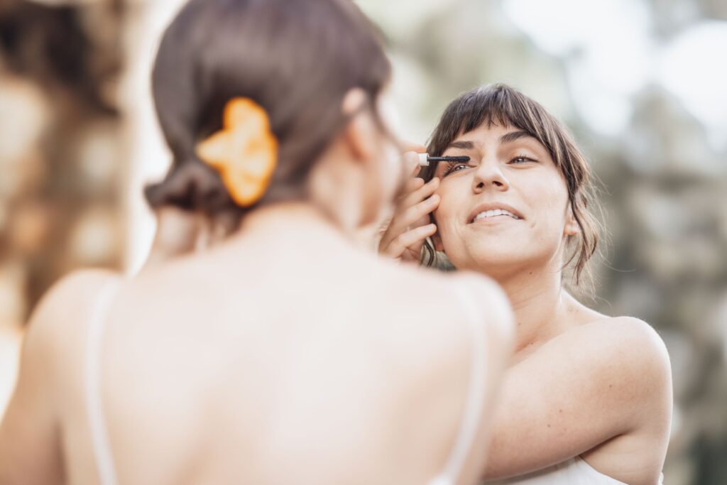 A person putting makeup on to prepare for their Colorado Elopement Wedding.