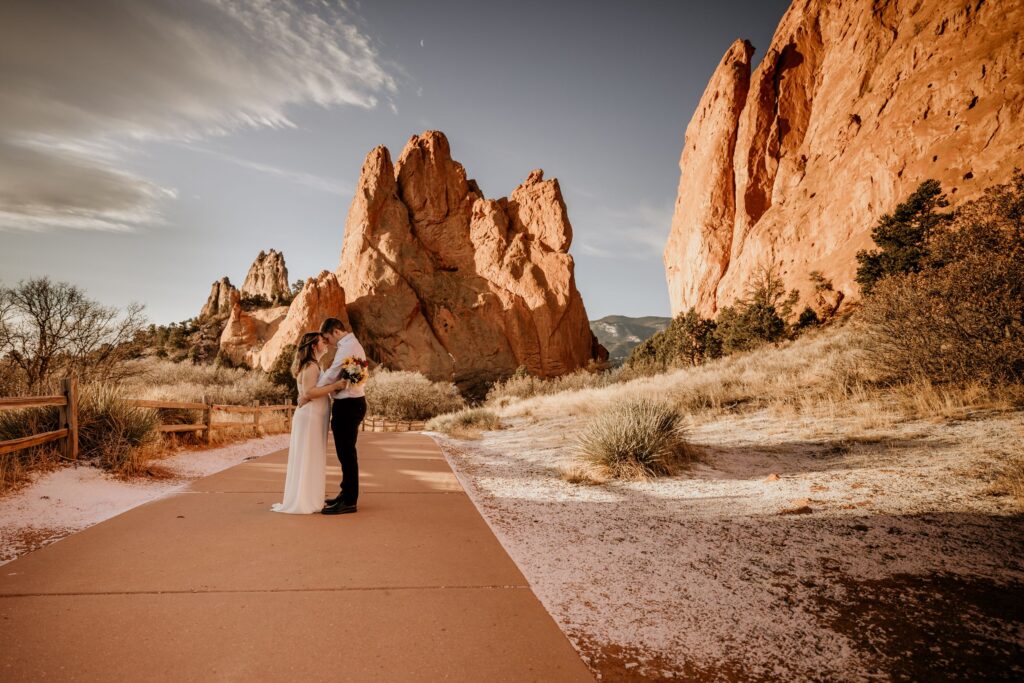 bride and groom walk down trail during colorado adventure elopement.