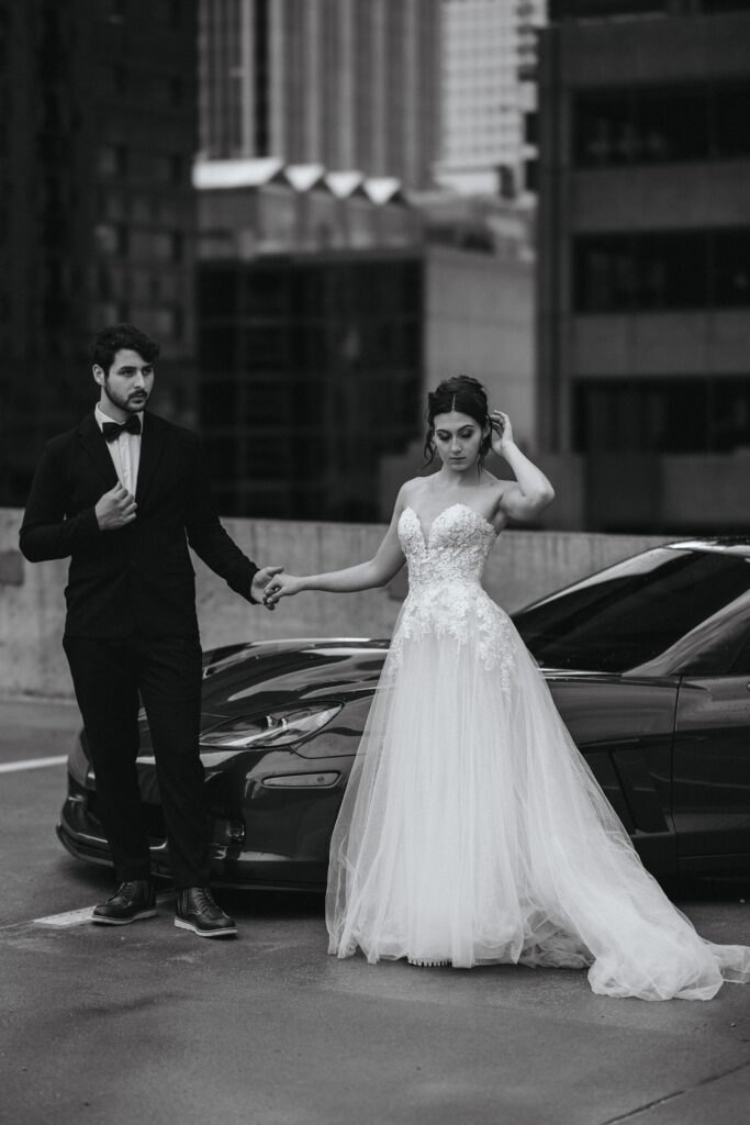 bride and groom pose on parking garage in downtown denver colorado during bridal portrait session.