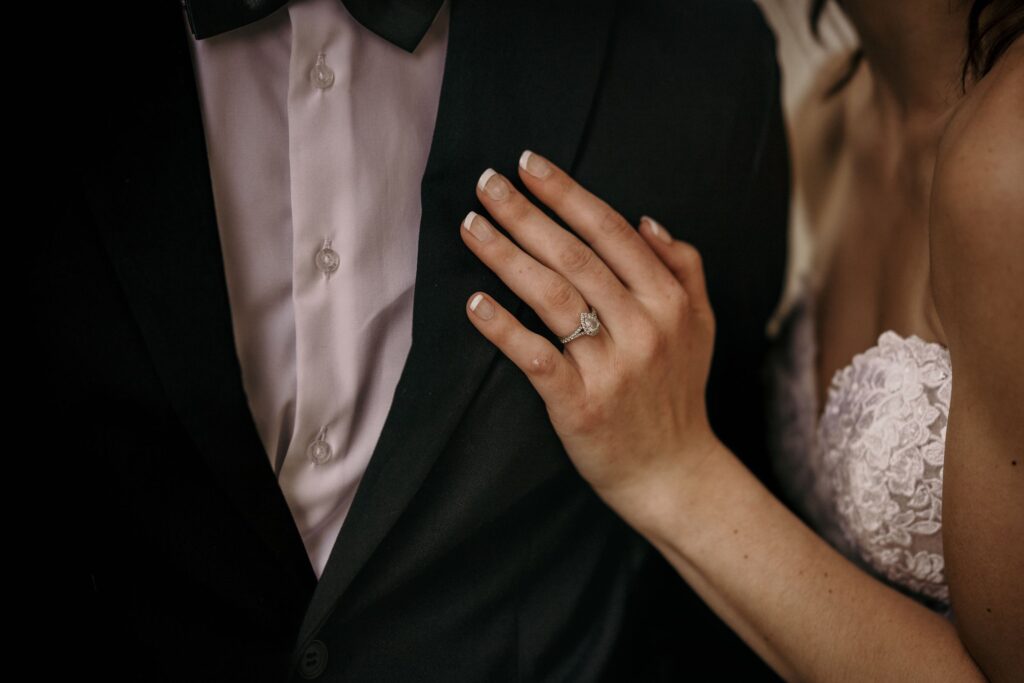 close up image of brides hand on grooms chest during colorado bridal portraits in downtown denver.