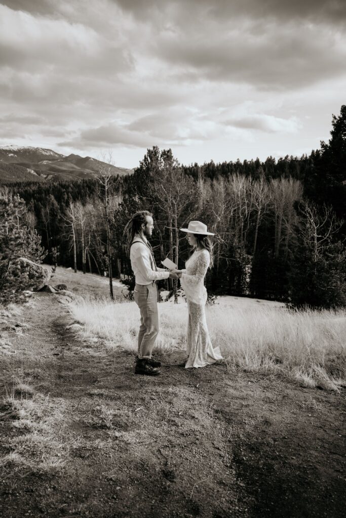 bride reads self written vows during colorado adventure elopement photo shoot.