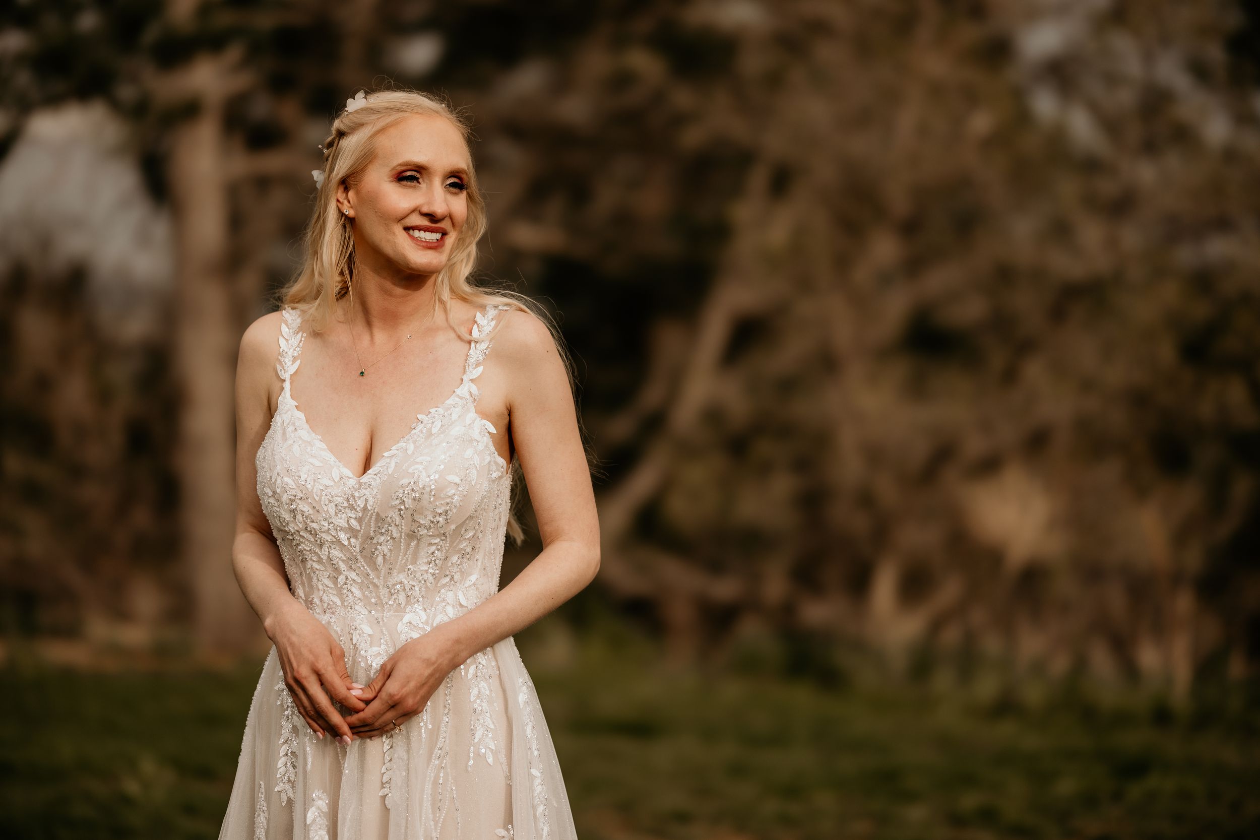 bride stands towards the colorado wedding photographer during wedding portrait photo session.
