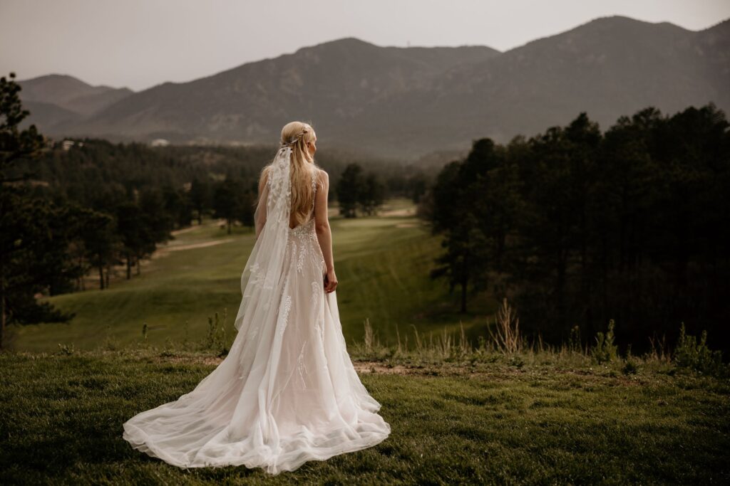 bride faces the mountains, during photos with colorado elopement photographer.