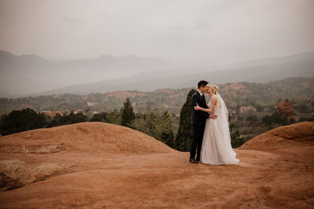 bride and groom kiss at colorado's garden of the gods during wedding photo session with colorado photographer.