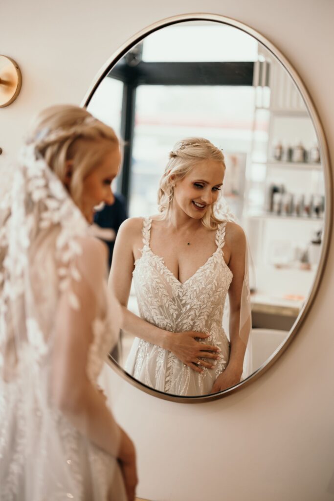 image of bride's reflection in mirror during pre wedding party photos with colorado elopement photographer.