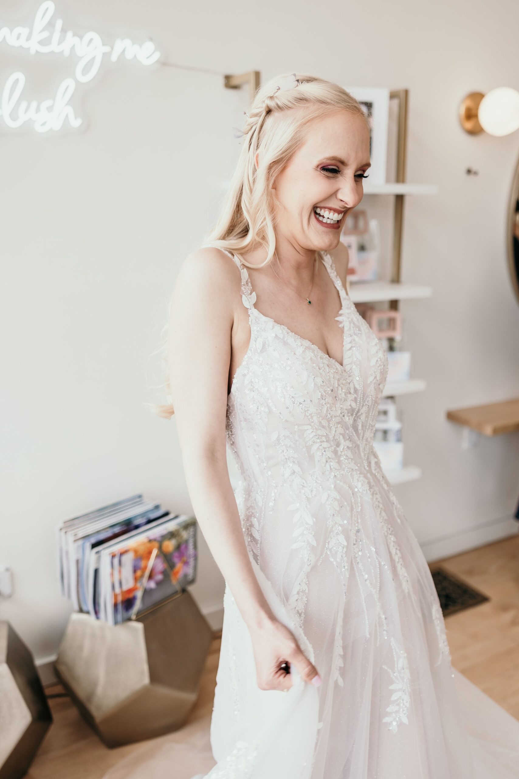 happy bride laughs during the getting ready wedding photos in colorado springs.