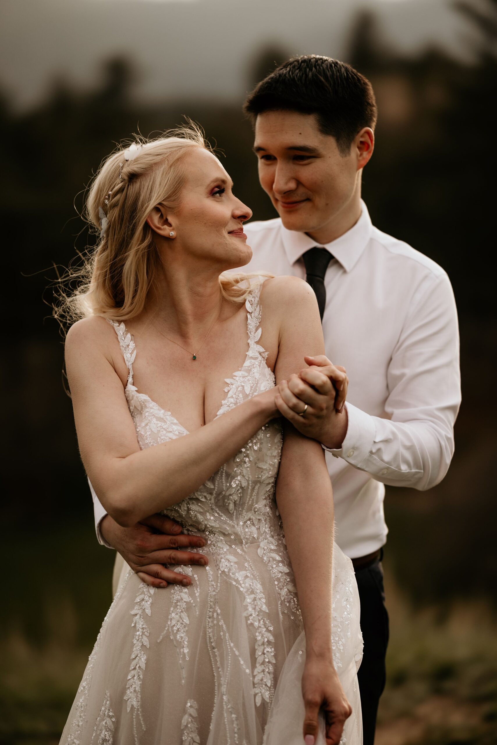 newlywed couple embraces each other during wedding portraits in colorado springs golf course.