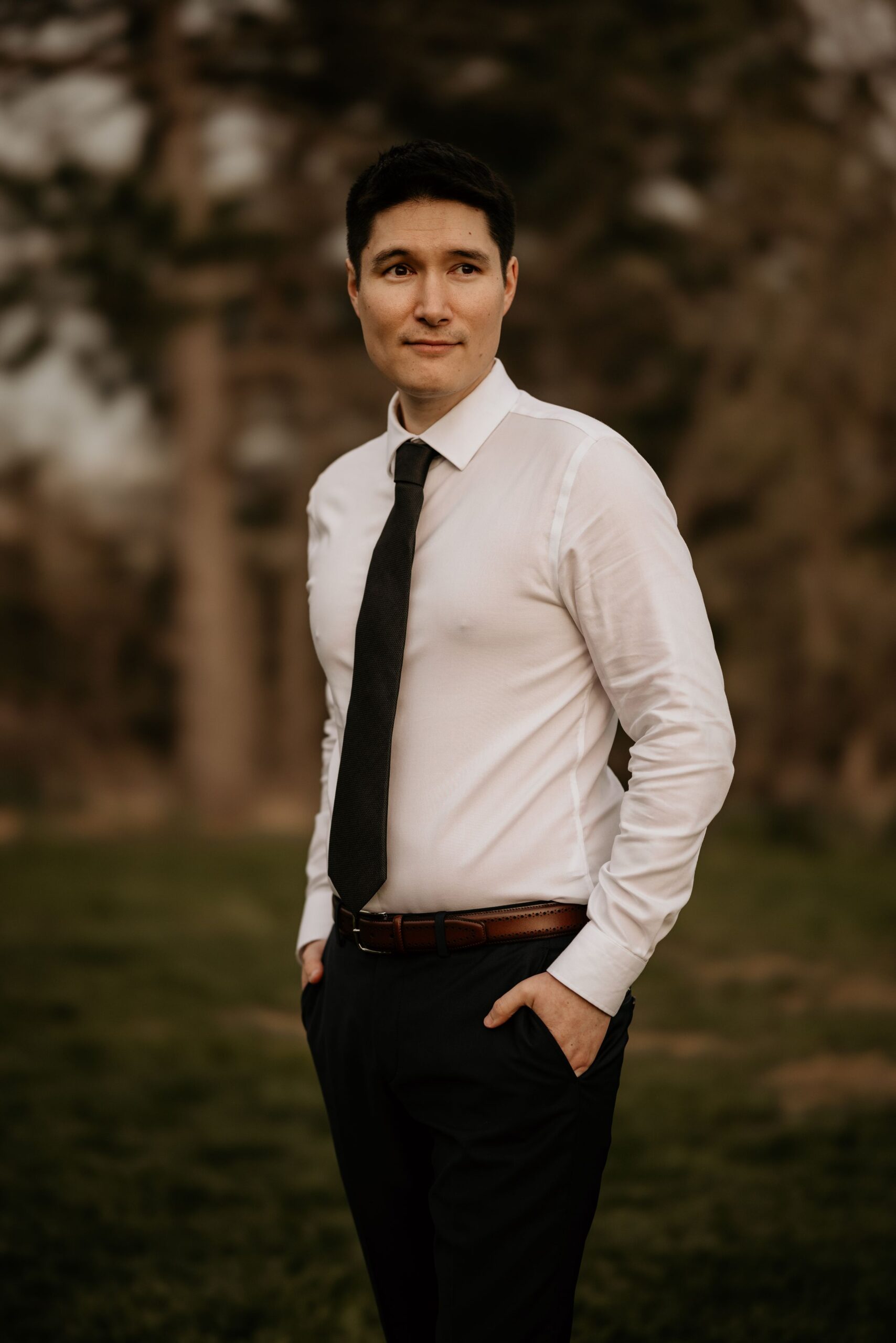 groom stands, hands in his pockets, during photos with colorado intimate wedding photographer.