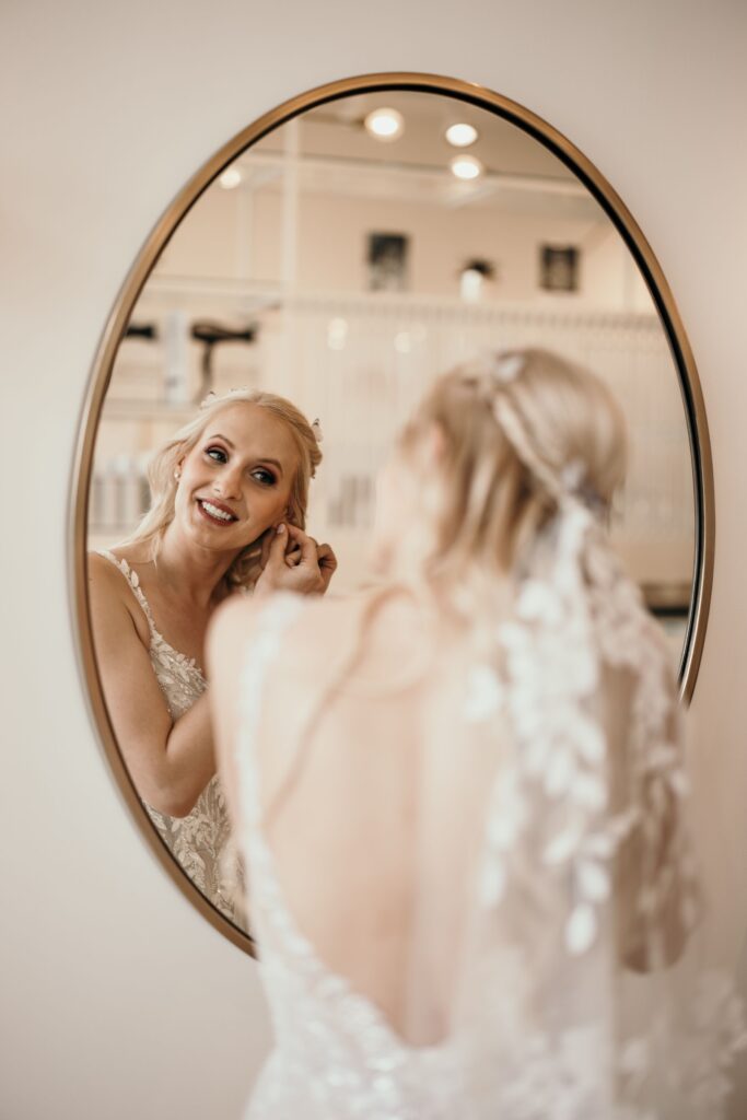 image of bride looking in the mirror, during pre-wedding photos with colorado wedding photographer.