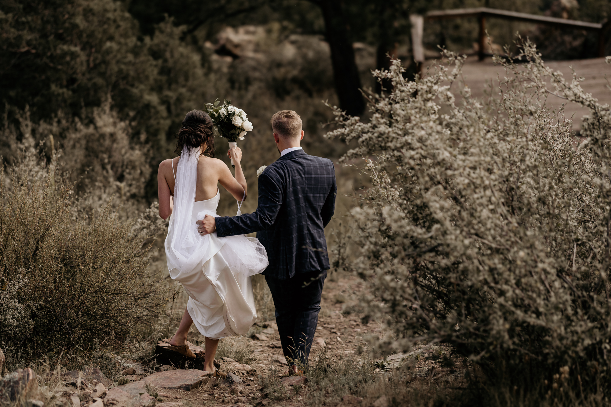 bride and groom walk together during sustainable mountain top micro wedding.