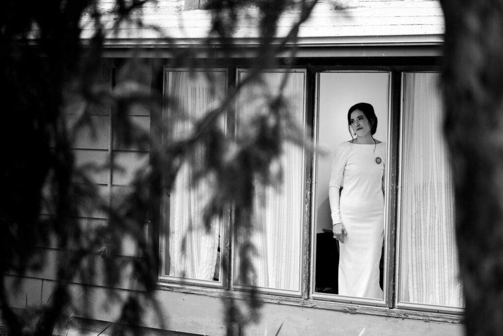 bride stands in the cottage at red bend wedding venue during her colorado micro wedding.