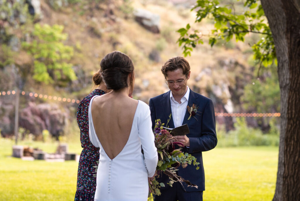 groom reads self written vows during colorado micro wedding ceremony.