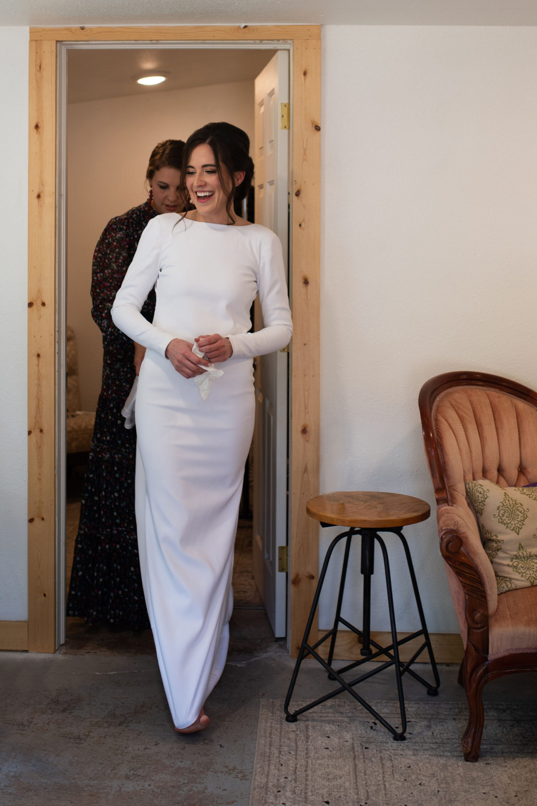 bride walks in cottage at river bend during colorado micro wedding.