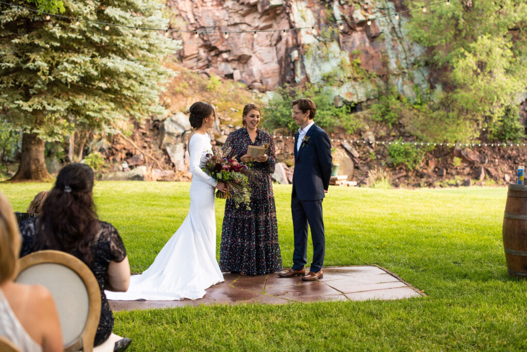 bride and groom during their micro wedding ceremony at river bend in lyons colorado.
