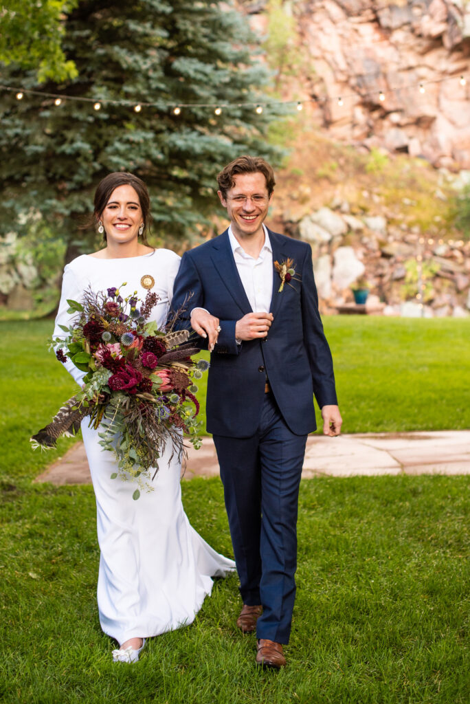 bride and groom walk down the aisle during colorado micro wedding ceremony at river bend venue.