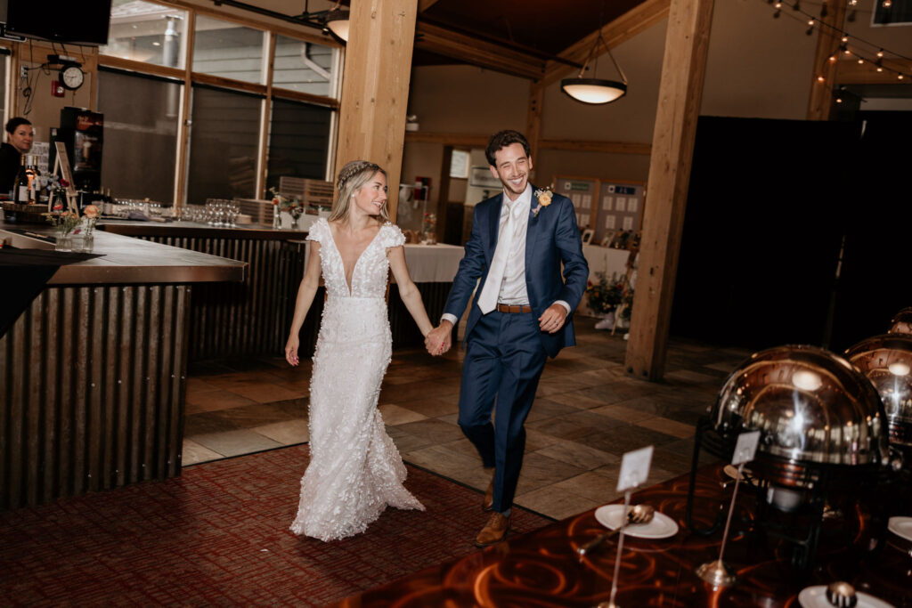 bride and groom walk into reception at ski mountain wedding at black mountain lodge.
