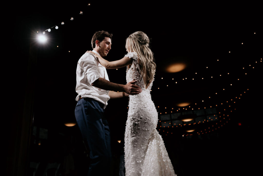 bride and groom do a first dance during wedding reception.