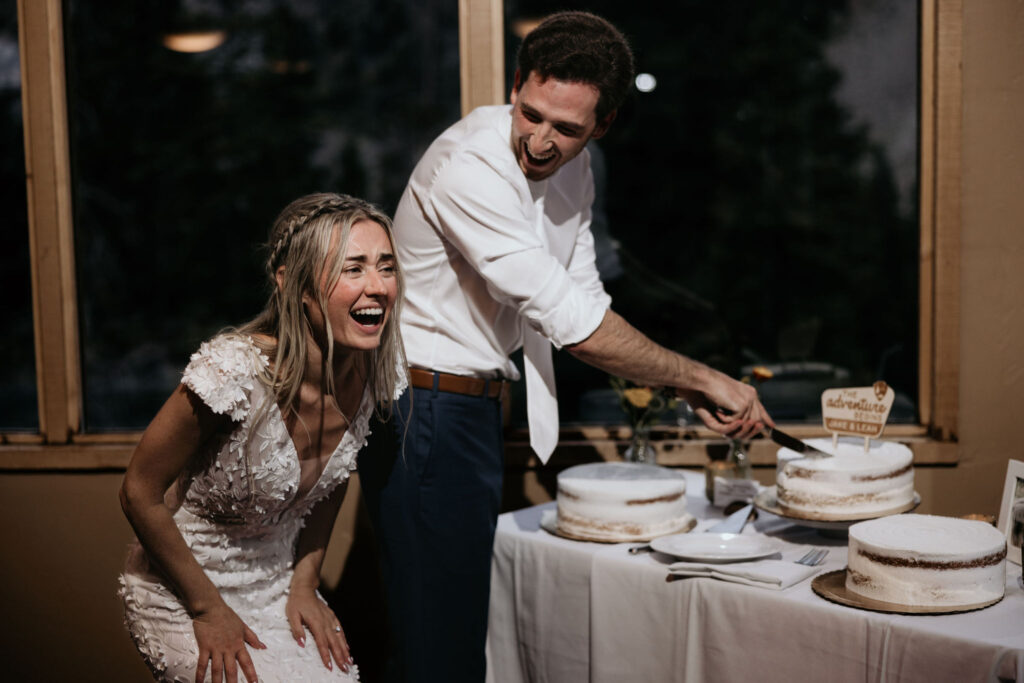 bride and groom cut the cake during ski mountain wedding in colorado.