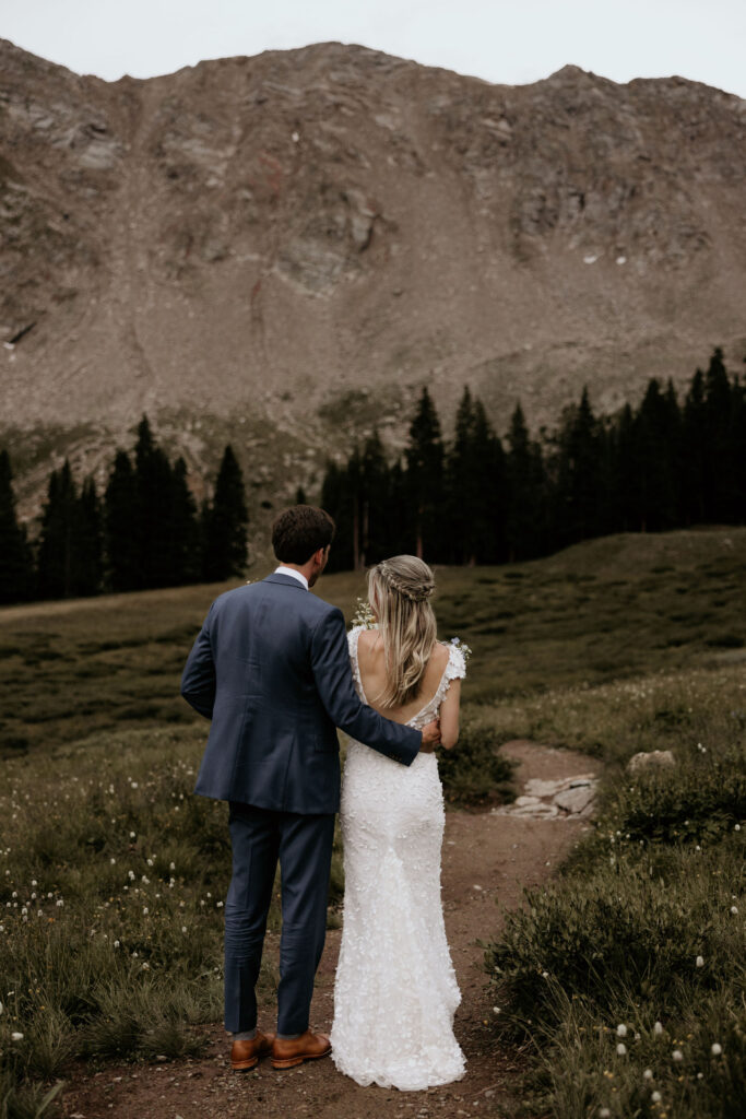 bride and groom take sunset photos during ski mountain wedding in colorado.