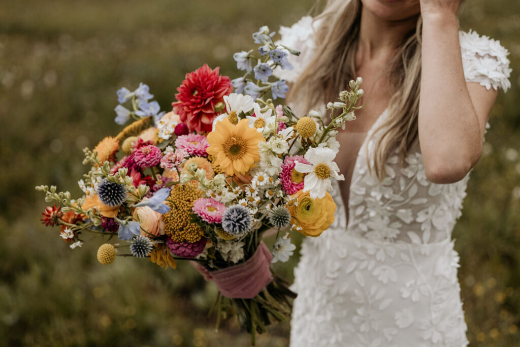 close up image of bride and floral bouquet during her colorado ski mountain wedding at black mountain lodge.