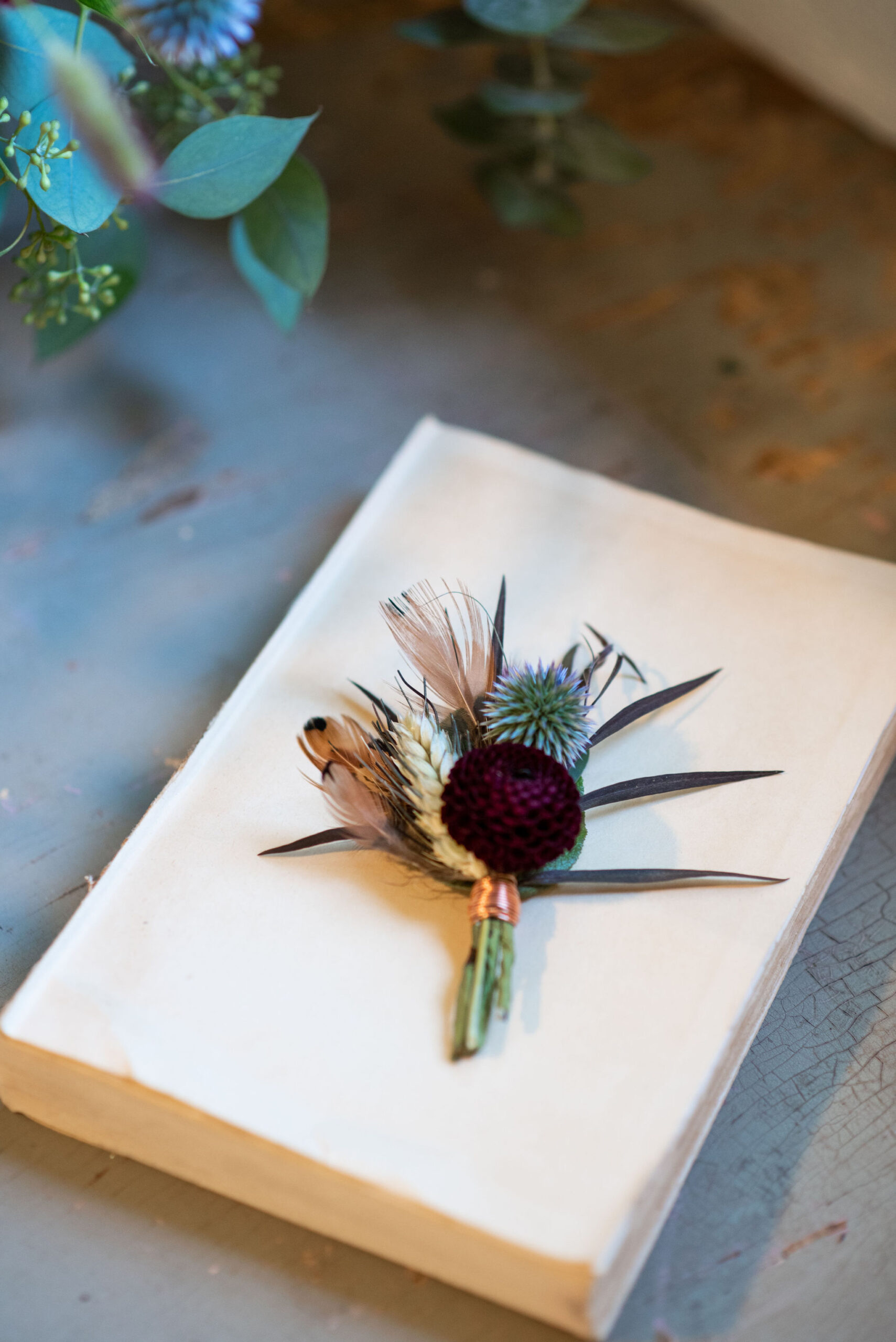 florals by Plume and Furrow sit on a book for a micro wedding in lyons colorado.
