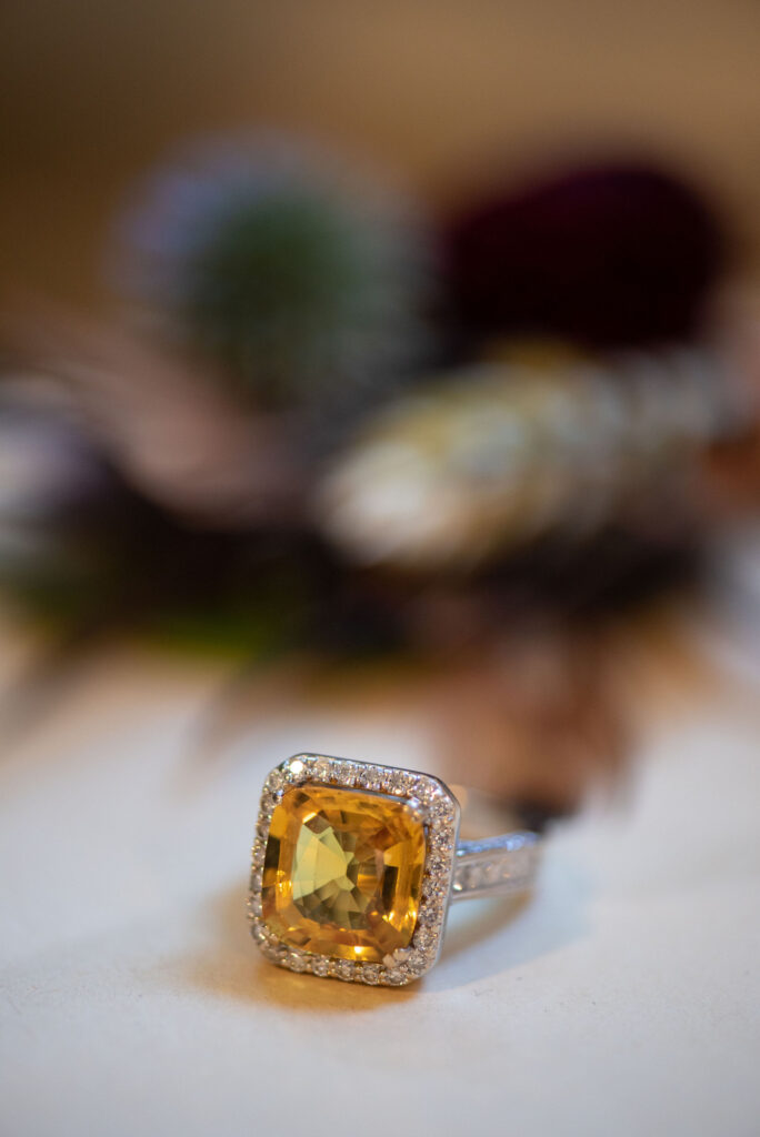 close up image of brides ring during her wedding at river bend in lyons colorado.