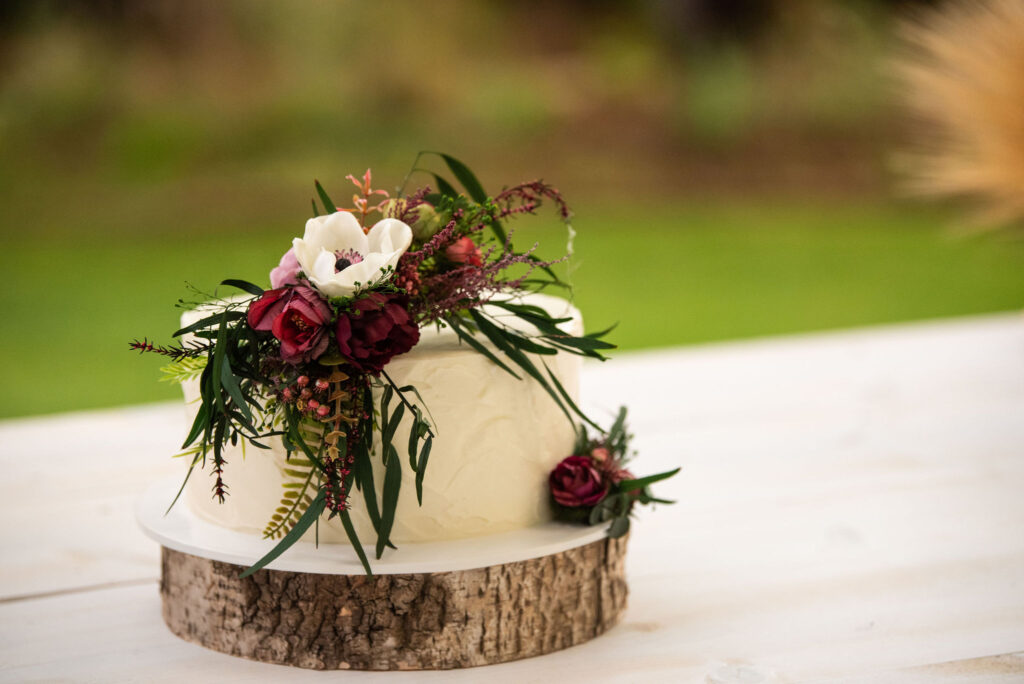 cake with florals on it made by The Makery for a colorado micro wedding at river bend.