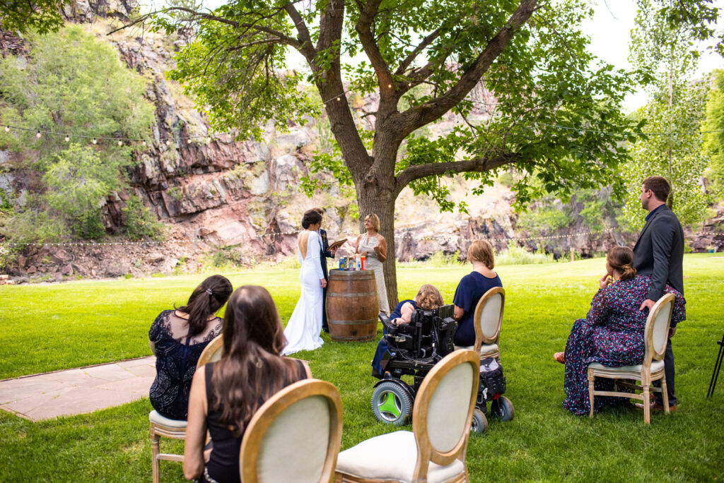 bride and groom hold candle ceremony during their colorado micro wedding.