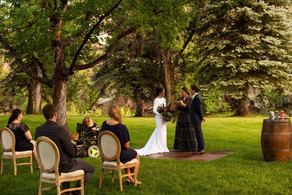 bride and groom during their micro wedding ceremony at river bend venue in lyons colorado.