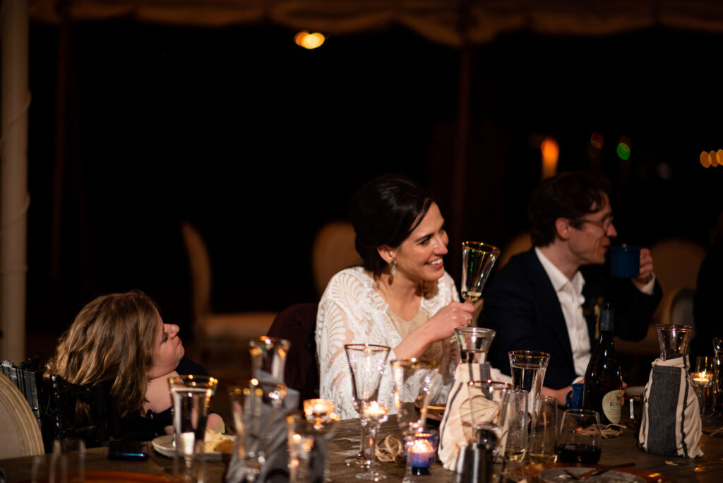 bride and groom enjoy dinner with their guest during colorado micro wedding at river bend.