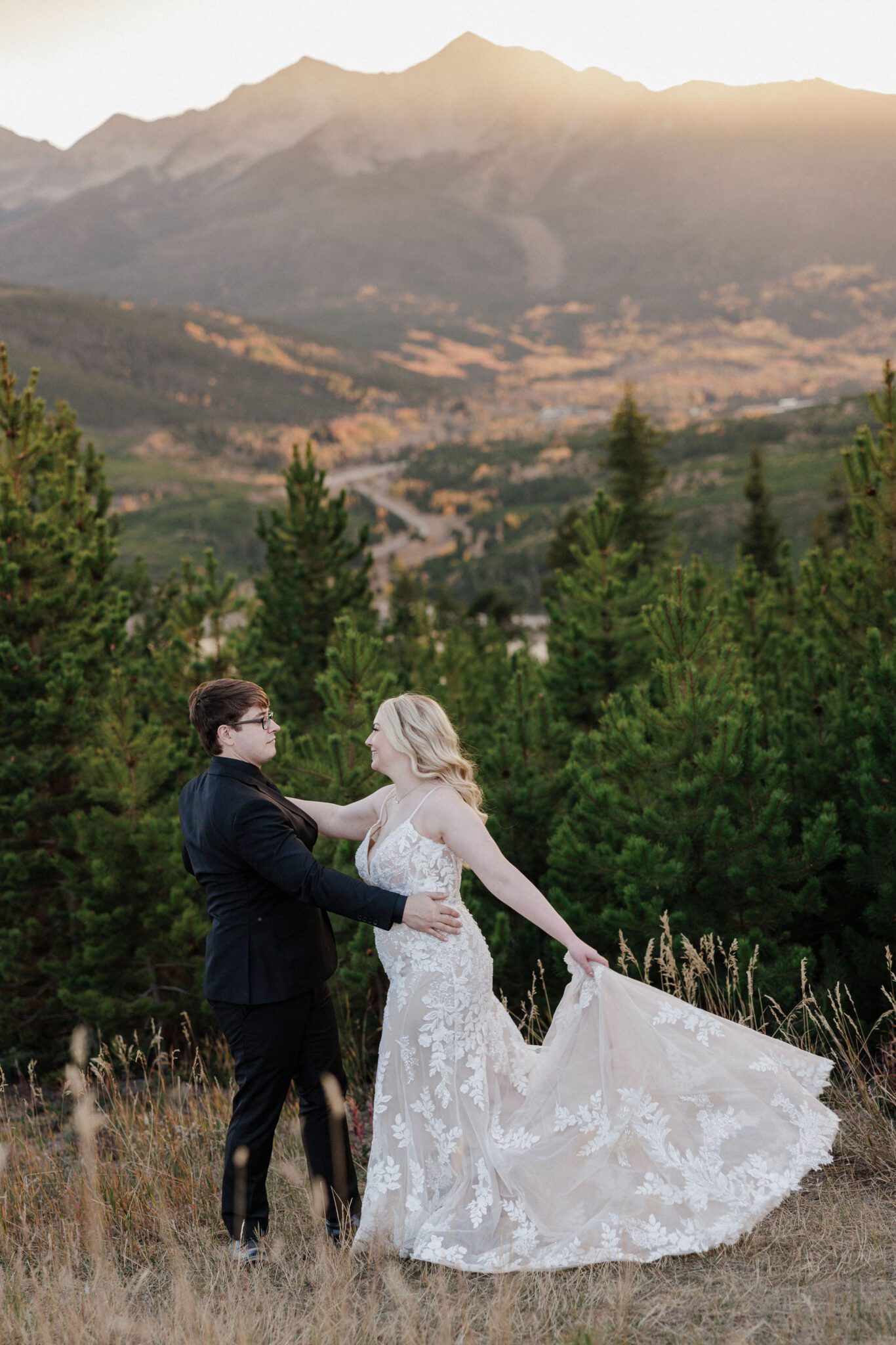 bride and groom dance during the sunset in the mountains, their best time to get married