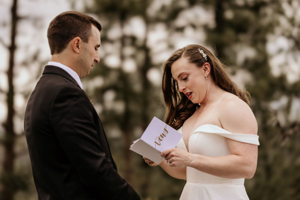 bride reads self written vows during mountain micro wedding in colorado.