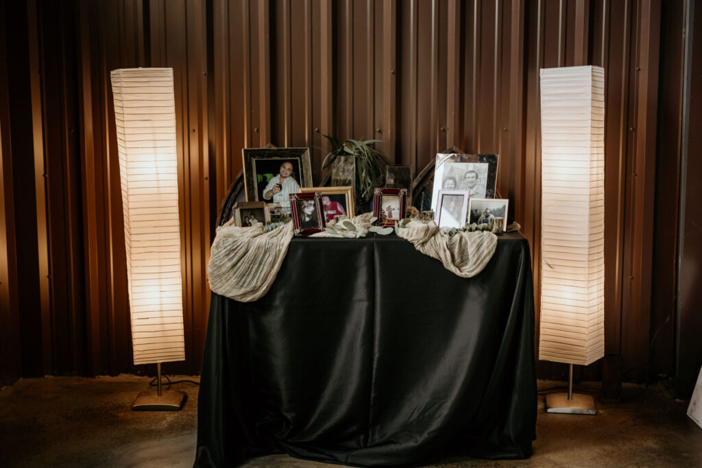table with photos of loved ones set up for a micro wedding in the colorado mountains.
