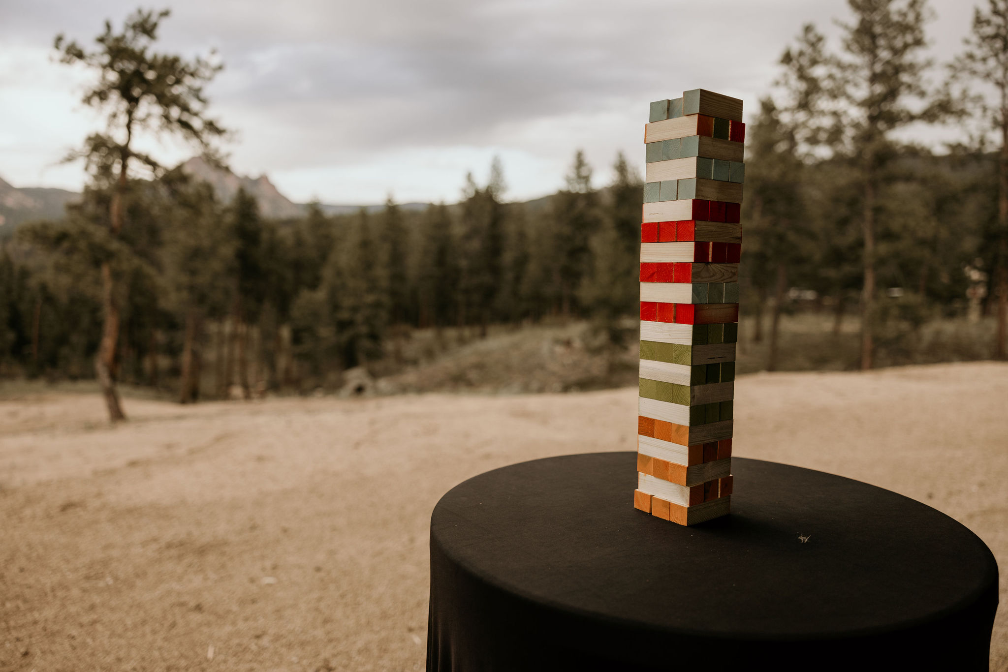 Jenga blocks are stacked up for a mountain top micro wedding reception in colorado.