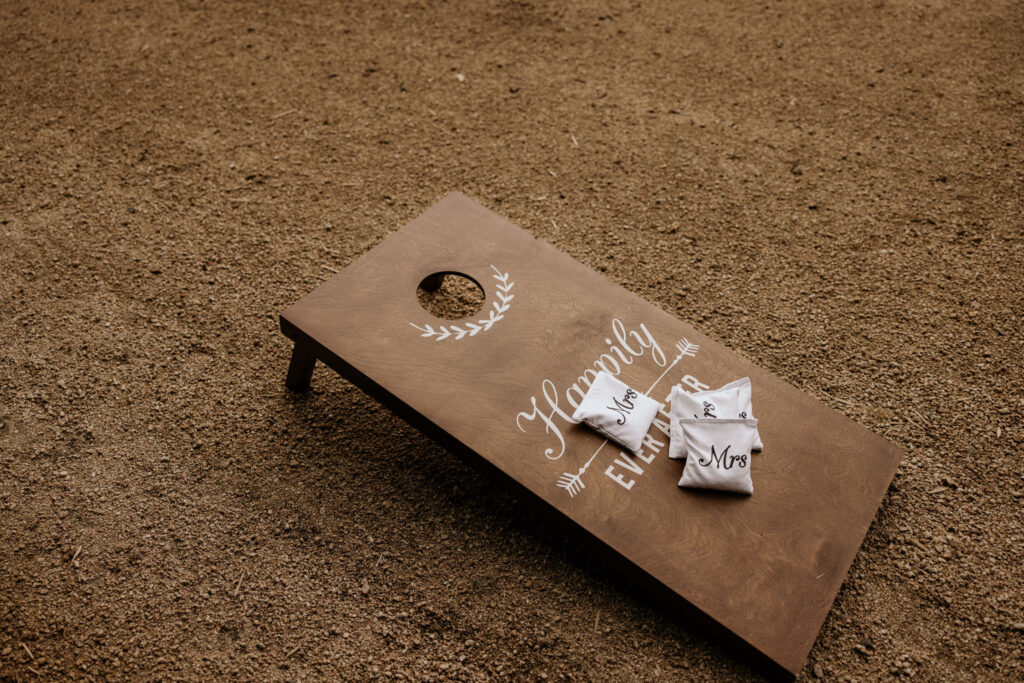 Cornhole boards are set up during a mountain top micro wedding reception in colorado.