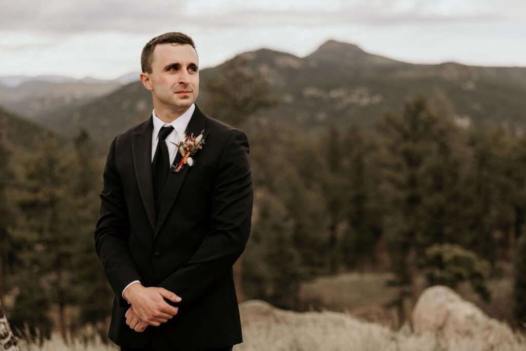 groom tears up seeing bride walk down aisle during colorado micro wedding in the mountains.