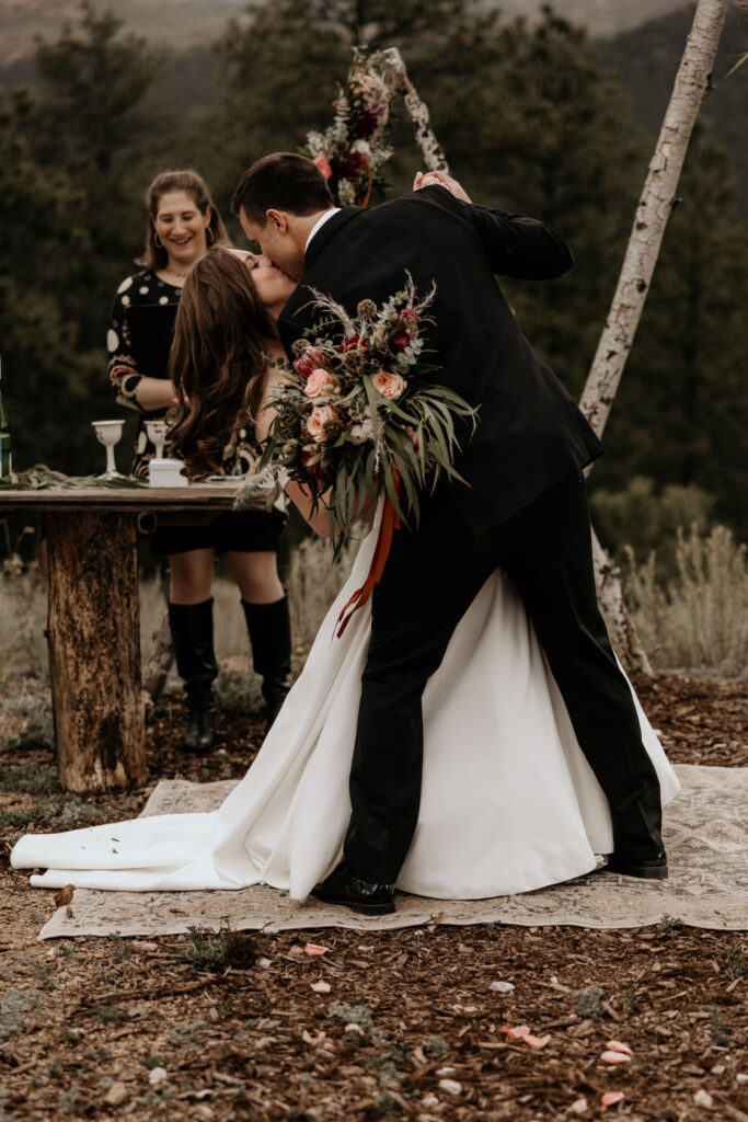 bride and groom kiss during colorado micro wedding in the mountains.