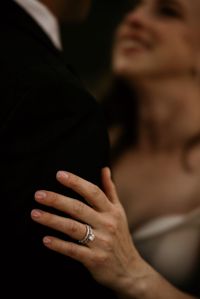 close up image of brides hand on grooms arm during colorado micro wedding.
